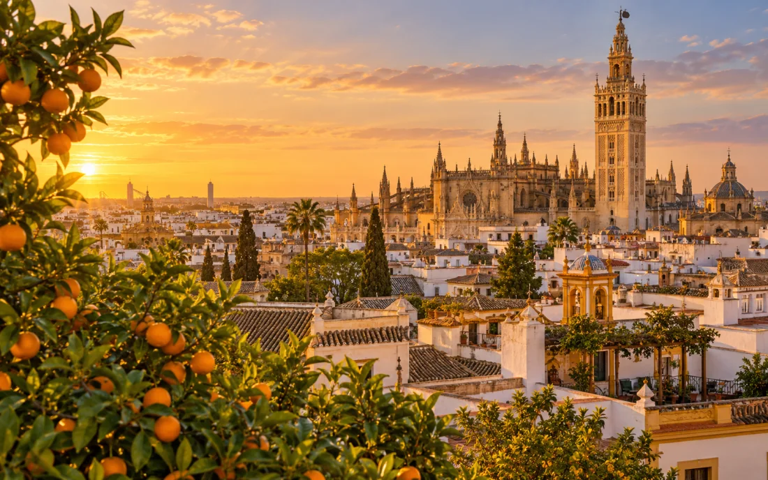 Seville rooftops, orange trees and the Giralda at golden hour
