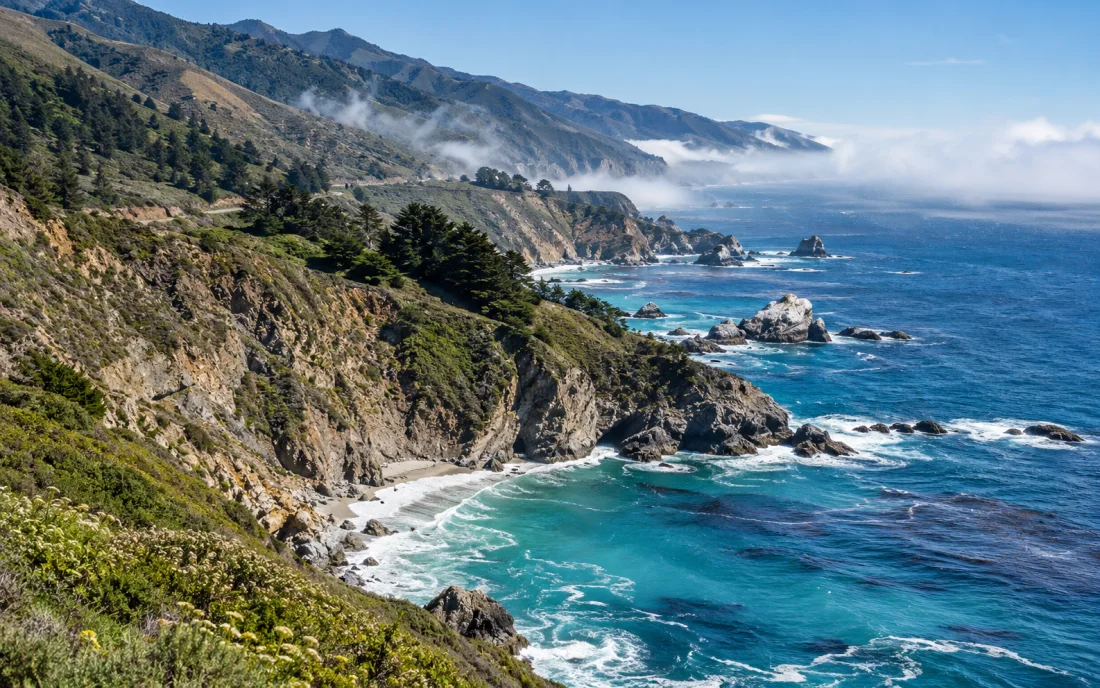 Big Sur cliffs and turquoise Pacific Ocean along California's misty coast